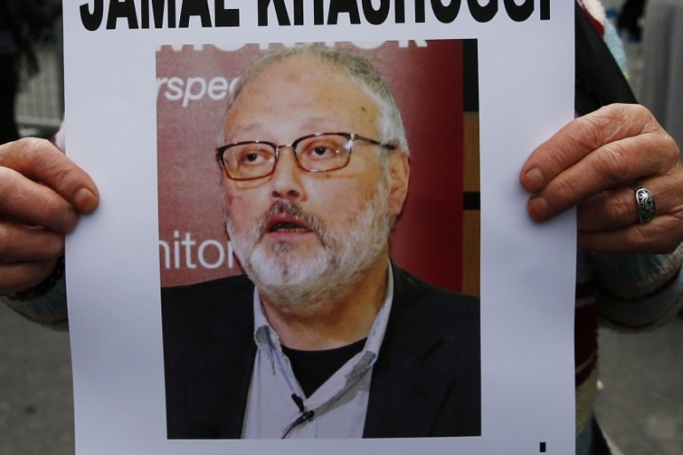 An activist, member of the Human Rights Association Istanbul branch, holds a poster with a photo of missing Saudi journalist Jamal Khashoggi, during a protest in his support near the Saudi Arabia cons