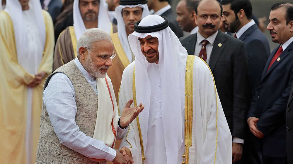 Indian Prime Minister Narendra Modi, left, gestures as he receives Abu Dhabi's crown prince, Sheikh Mohammed bin Zayed Al Nahyan at the airport in New Delhi, India, Tuesday, Jan. 24, 2017. The crown p