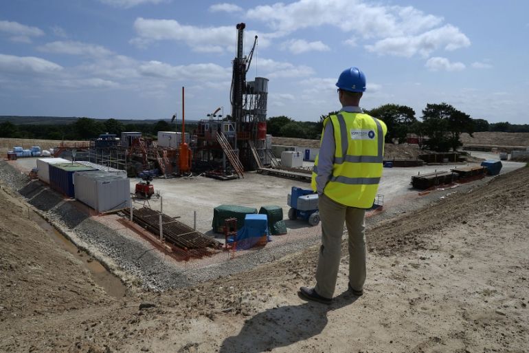 An employee poses for a photograph at the Sirius Minerals test drilling station on the North Yorkshire Moors near Whitby, northern England July 5, 2013