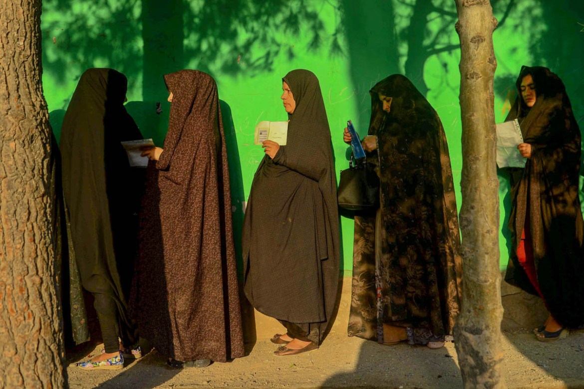Women queue to cast their vote at a polling station in Herat on September 28, 2019. Afghans headed to the polls amid tight security on September 28 as voting got under way in the presidential election
