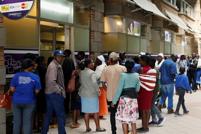 People queue to withdraw cash from a local bank in Harare, Zimbabwe, September 9, 2019