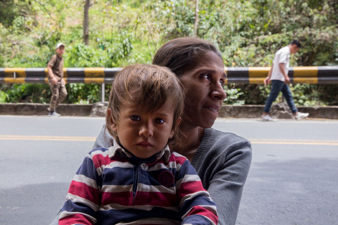Maribel Saez a 36-year-old migrant from Trujillo, Venezuela holds her two-year-old son on the side of the mountain road where they rest. They''ve been walking for 11 days and don''t know where they will