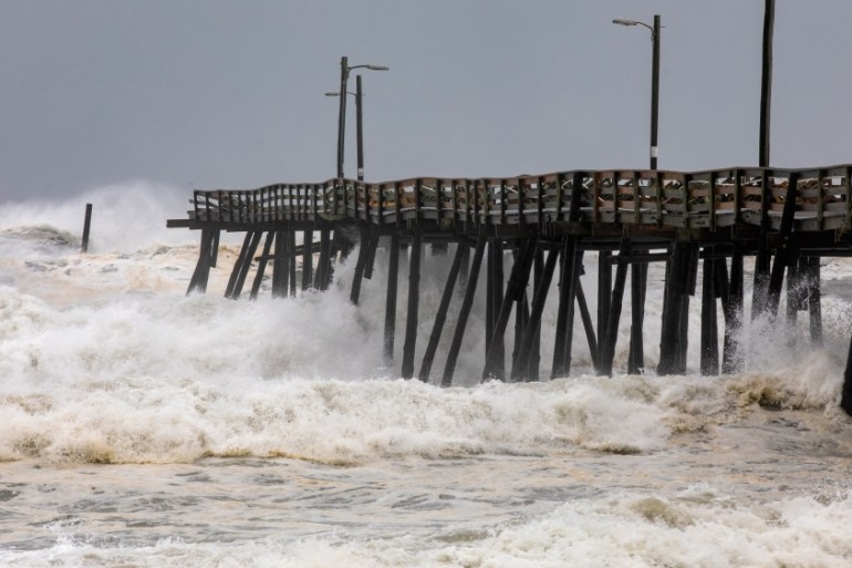 Waves from Hurricane Dorian damage Nags Head Fishing Pier, North Carolina, USA.