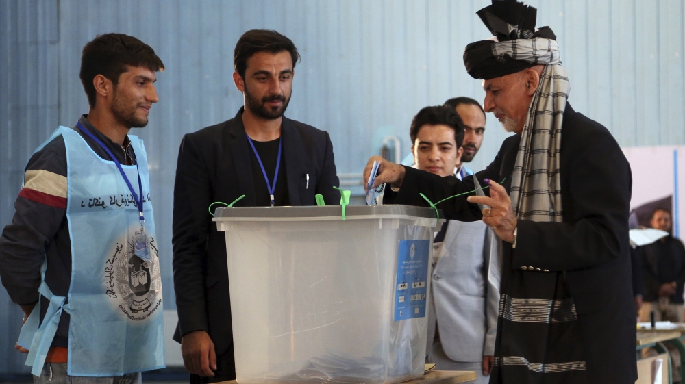 Afghan President Ashraf Ghani, right, casts his vote at Amani high school, near the presidential palace in Kabul, Afghanistan, Saturday, Sept. 28, 2019. Afghans headed to the polls on Saturday to elec