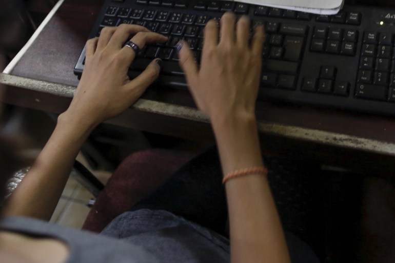 A woman uses the internet at an internet cafe in Yangon, Myanmar