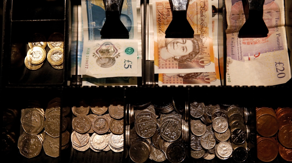 Pound Sterling notes and change are seen inside a cash resgister in a coffee shop in Manchester, Britain, September 21, 2018