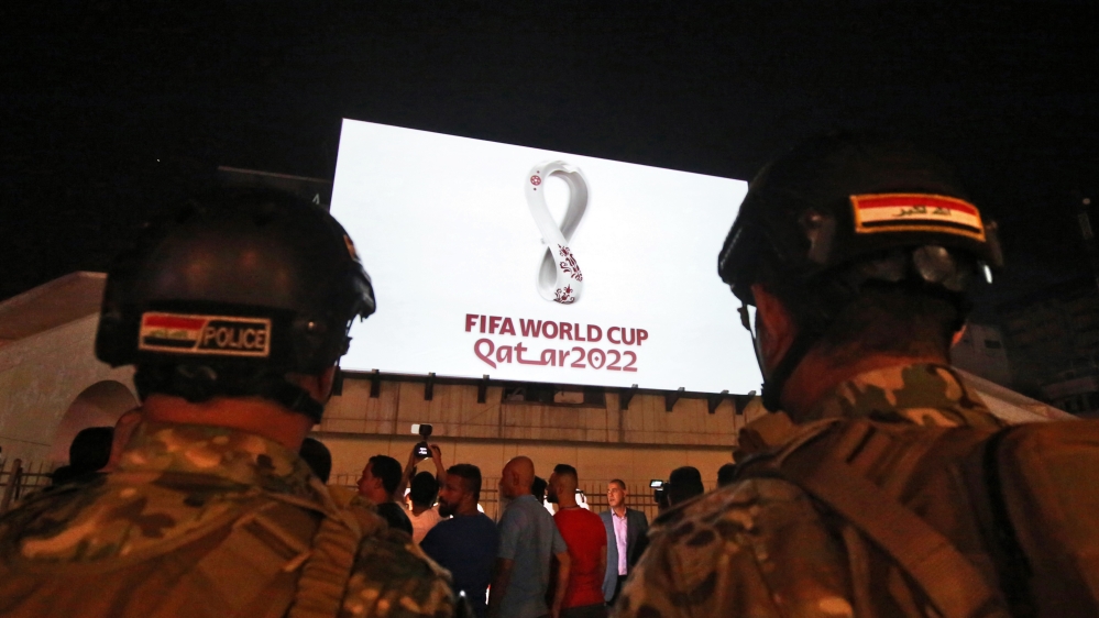 Iraqis gather at Baghdad's Tahir square as the official logo of the FIFA World Cup Qatar 2022 is projected on the front of a building on September 3, 2019. Qatar unveiled the logo for the 2022 World C