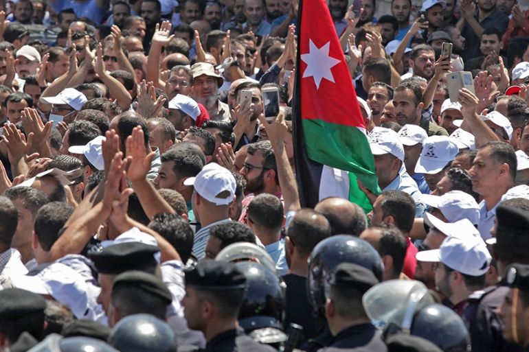 Jordanian teachers chant slogans and wave their national flag during a protest in the capital Amman on September 5, 2019. - Thousands of public school teachers marched in central Amman demanding highe