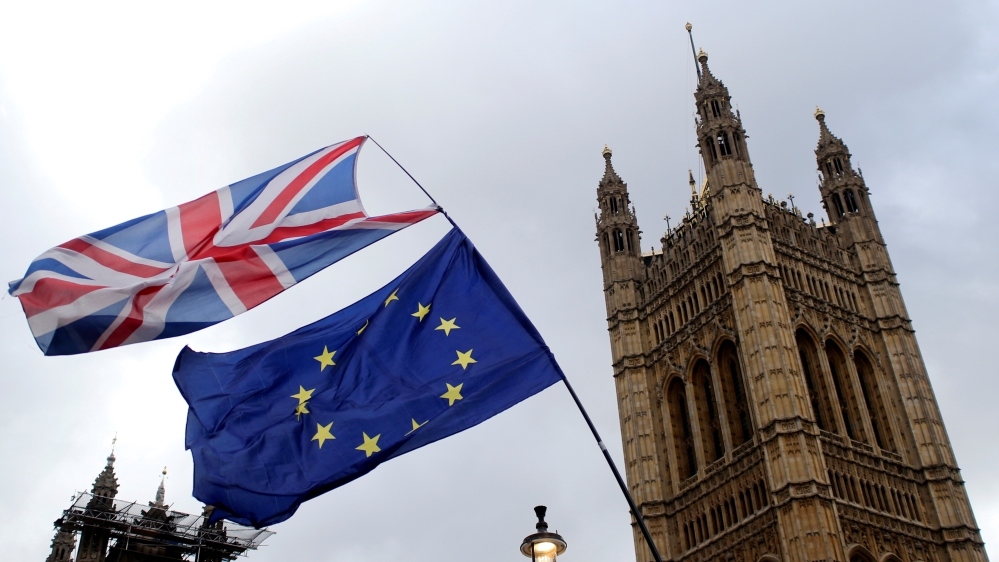 Flags flutter outside the Houses of Parliament, ahead of a Brexit vote, in London, Britain March 13, 2019