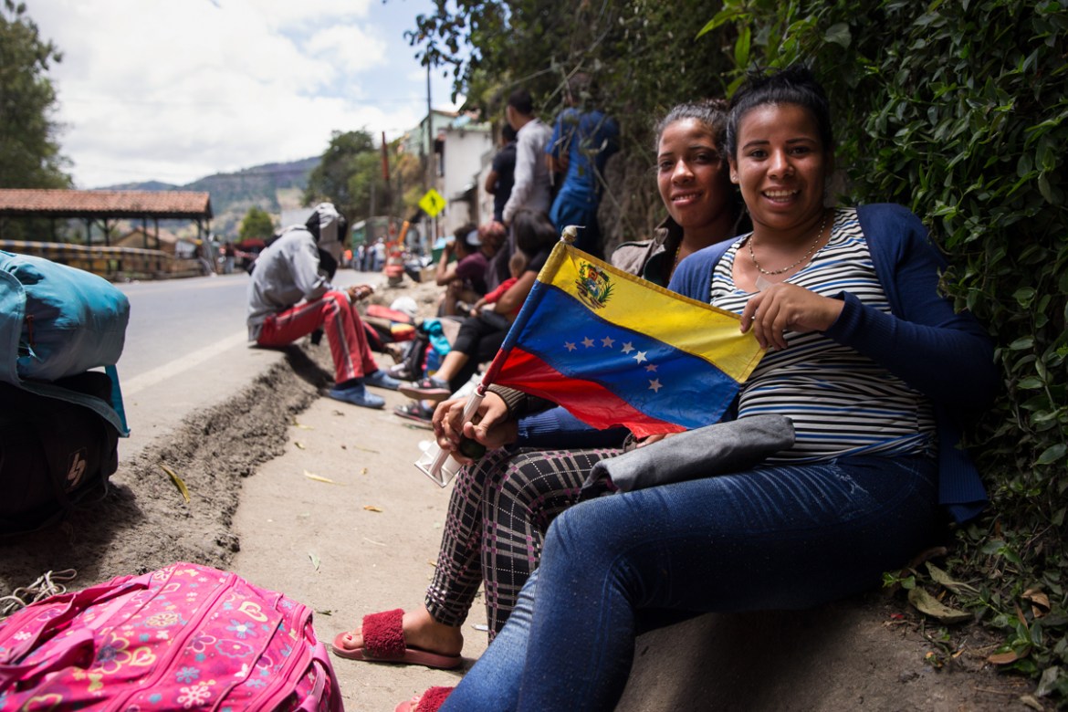 Sisters Jennifer Borges, 19, and Yenireth Borges, 20, from Maracai, Venezuela sit outside a makeshift refuge in Pamplona, Colombia, and war jackets, prepared for the freezing, rainy nights that the re