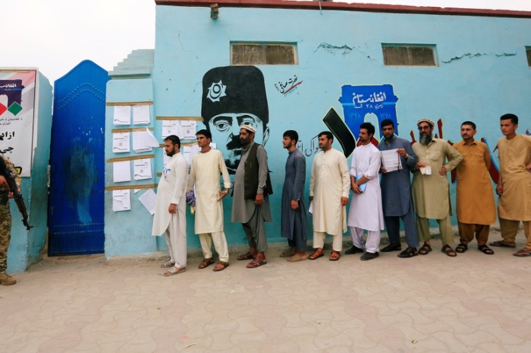 Men arrive to cast their votes outside a polling station in the presidential election in Jalalabad, Afghanistan September 28, 2019. REUTERS/Parwiz