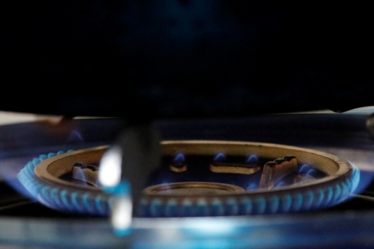A gas flame burns on a newly installed stove in a kitchen in Xiaozhangwan village at the outskirts of Beijing