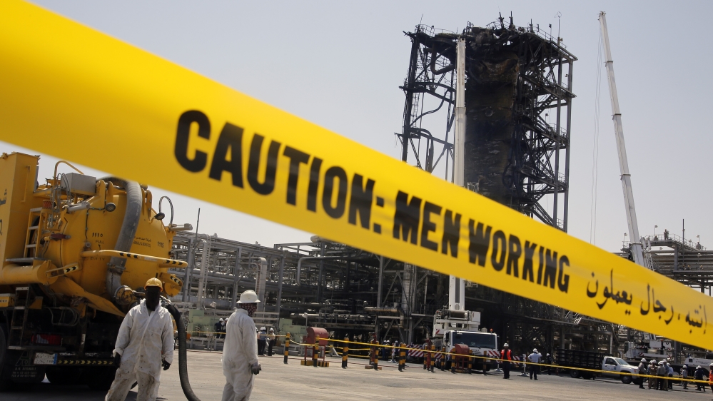 In this photo opportunity during a trip organized by Saudi information ministry, workers work in front of the recent attack Aramco's oil processing facility in Khurais, near Dammam