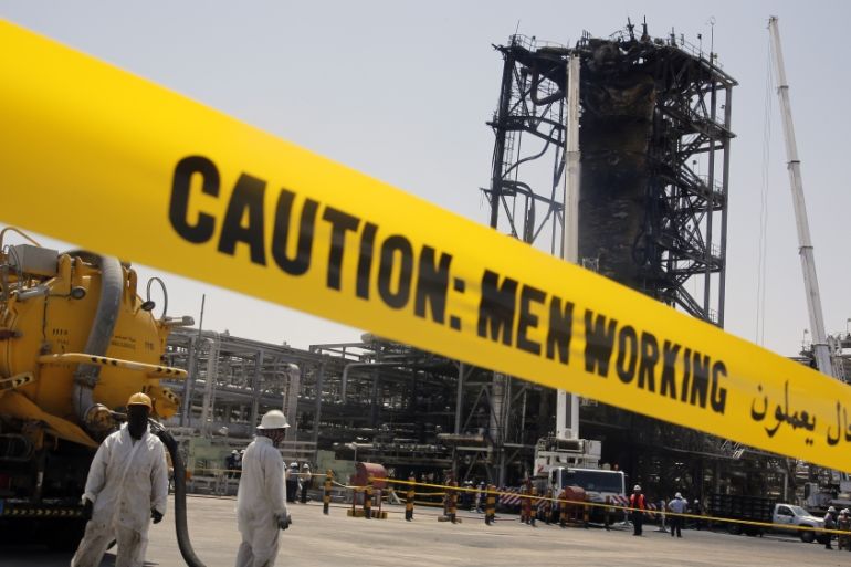 In this photo opportunity during a trip organized by Saudi information ministry, workers work in front of the recent attack Aramco''s oil processing facility in Khurais, near Dammam
