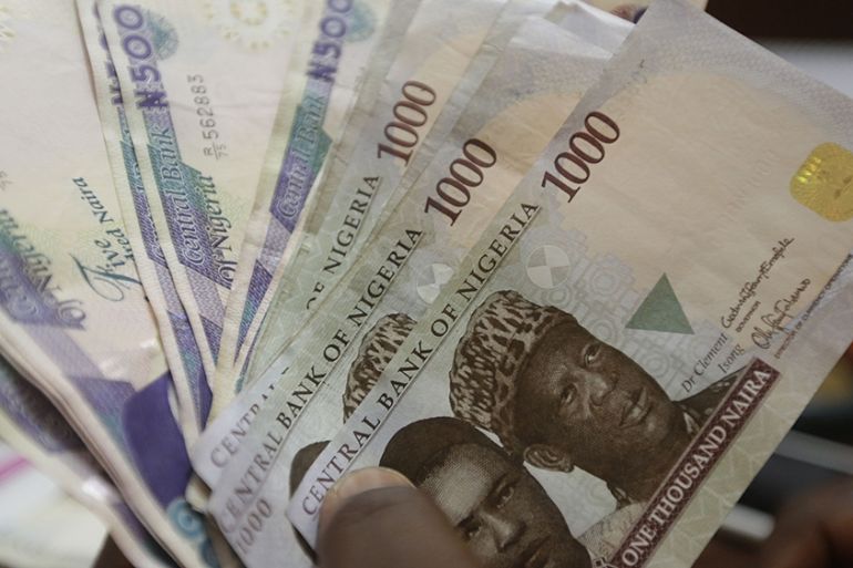 A money changer counts Nigerian naira at a bureau de change, in Lagos, Nigeria [Sunday Alamba/AP Photo]