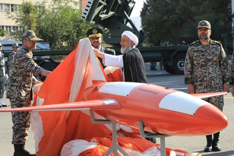 A handout picture released by the Iranian Army office on September 1, 2019, shows Brigadier-General Alireza Sabahifard (C), commander of the Army Air Defence force, unveiling a new drone dubbed "Kian"