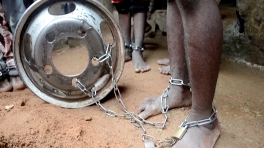 People with chained legs are pictured after being rescued from a building in the northern city of Kaduna