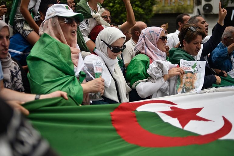 Algerian protesters chant slogans and wave their national flag during a demonstration against the ruling class in the capital Algiers on September 13, 2019, for the 30th consecutive Friday since the m