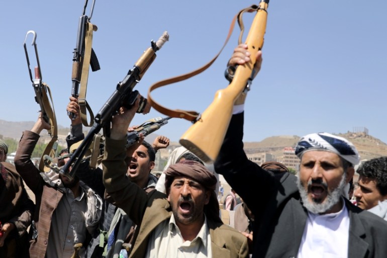 Houthi followers attend a gathering to receive food supplies from tribesmen in Sanaa