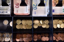 Euro banknotes and coins are displayed in a shop in Brussels, Belgium [File: Eric Vidal/Reuters]