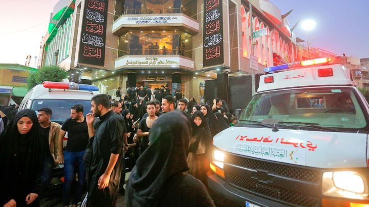People gather outside a hospital while ambulances bring injured people after a walkway collapsed and set off a stampede as thousands of Shiite Muslims marked one of the most solemn holy days of the ye