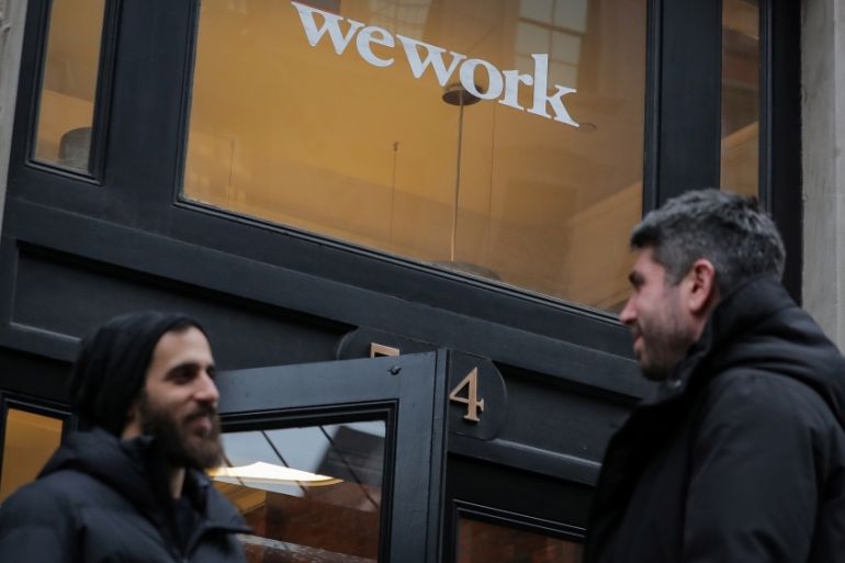 People stand outside a WeWork co-working space in New York