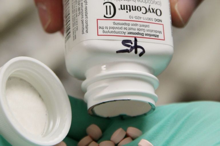 A pharmacists holds OxyContin pills made by Purdue Pharma at a pharmacy in Provo, Utah