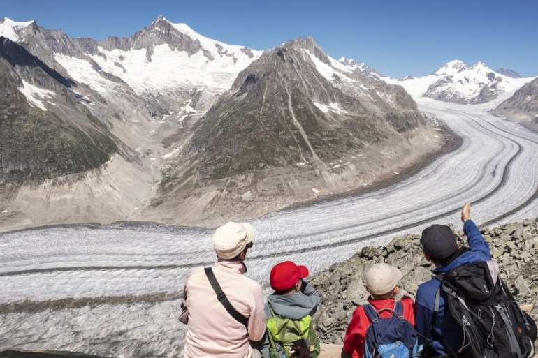 Hikers enjoy the Valais mountain scenery from the Eggishorn (2869m) with a view on the Great Aletsch glacier, above Fiesch, Switzerland, 18 July 2018.