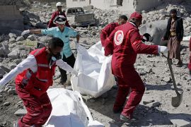 Rescue workers carry the body of a detainee from under the rubble of a Houthi-held detention center destroyed by Saudi-led airstrikes in Dhamar, Yemen, Sunday, Sept. 1, 2019. Yemeni officials say airs