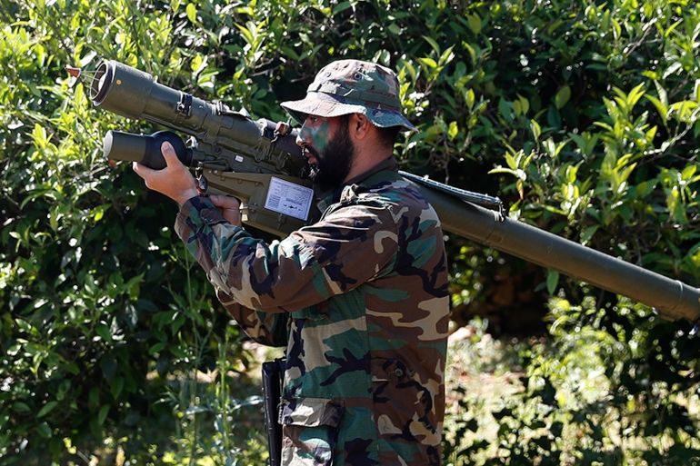 A Hezbollah fighter holds an Iranian-made anti-aircraft missile as he takes his position between orange trees, at the coastal border town of Naqoura, south Lebanon, Thursday, April 20, 2017. (AP Photo