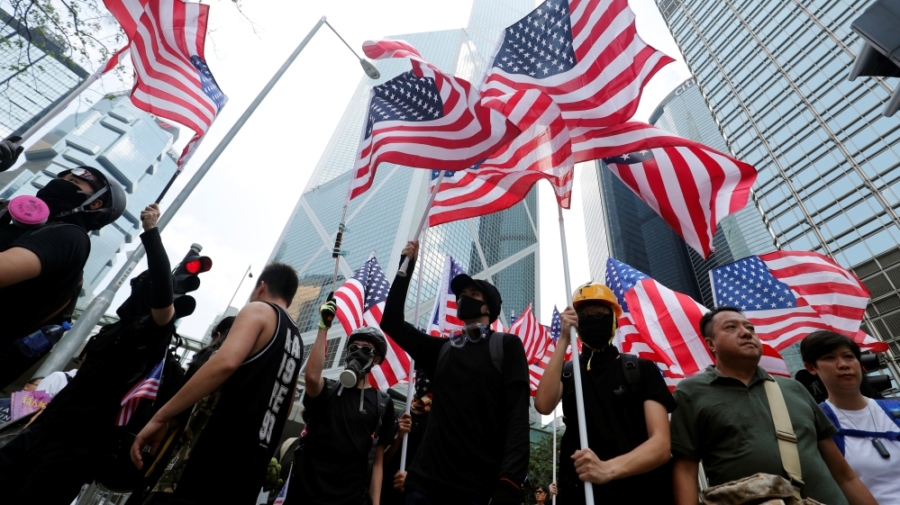 Protestors wave the U.S. flags as they march to the Consulate General of the United States at Hong Kong