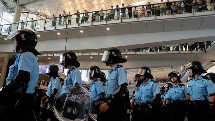 Police personnel take positions as pro-democracy protestors gather outside the airport in, Hong Kong, Sunday, Sept.1, 2019. The operator of the express train to Hong Kong''s airport has suspended servi
