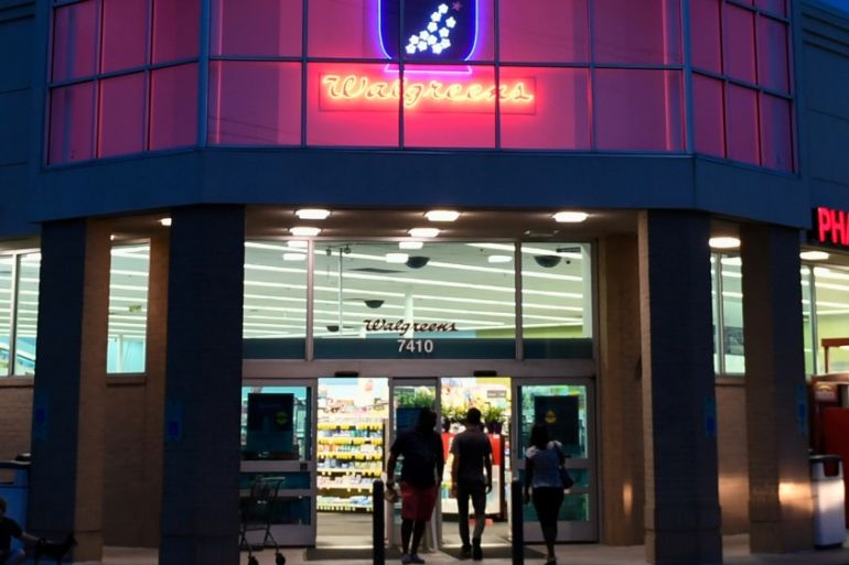 A customer walks out of a Walgreens pharmacy store in Austin, Texas