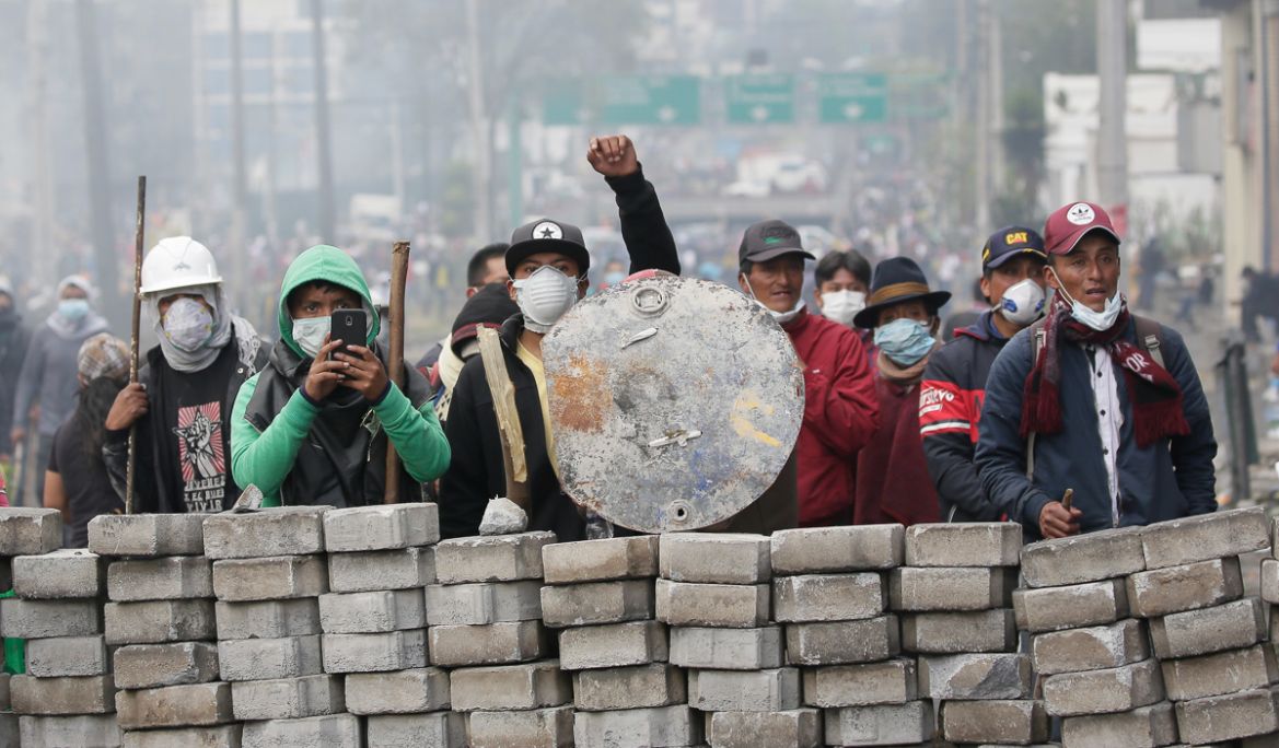 Anti-government demonstrators man a barricade during clashes with the police, near the national assembly building in Quito, Ecuador, Saturday, Oct. 12, 2019. Indigenous leaders of protests that have p