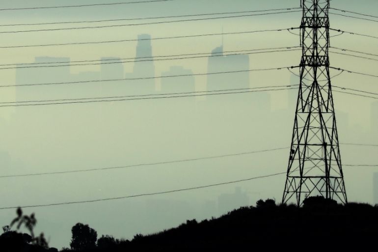 Downtown Los Angeles is seen behind an electricity pylon through the morning marine layer in Los Angeles
