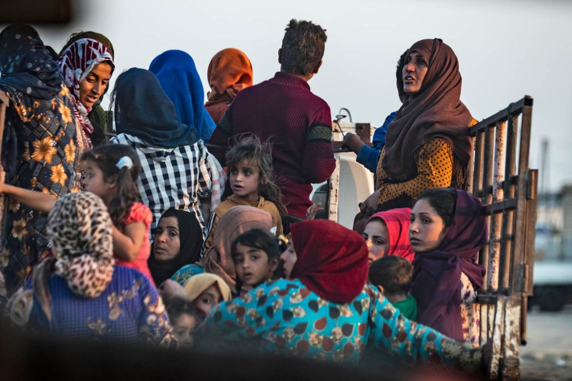 Syrian Arab and Kurdish civilians flee amid Turkish bombardment on Syria''s northeastern town of Ras al-Ain in the Hasakeh province along the Turkish border on October 9, 2019. Turkey launched a broad