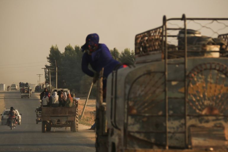 Syrians flee shelling by Turkish forces in Ras al Ayn, northeast Syria, Wednesday, Oct. 9, 2019.