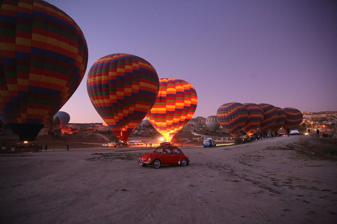 Hot air balloons ready to glide over Goreme district during early morning at the historical Cappadocia region, located in Central Anatolia''s Nevsehir province, Turkey on September 23, 2019. Cappadocia
