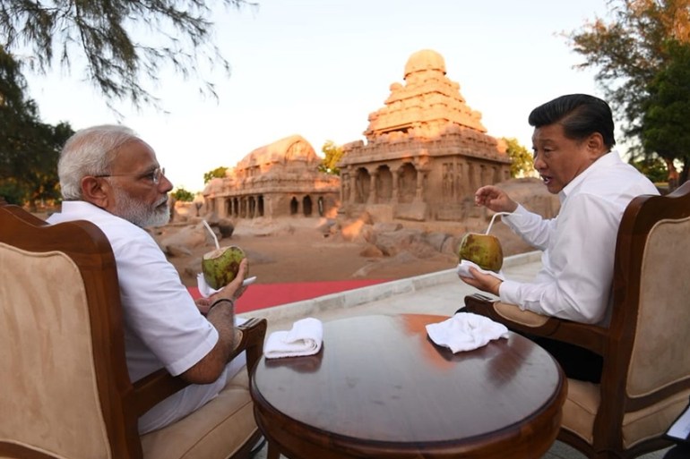 A handout photo made available by the Indian Press Information Bureau (PIB) shows Indian Prime Minister Narendra Modi (L) and Chinese President Xi Jinping at the ''five chariots'' monument during the 2n