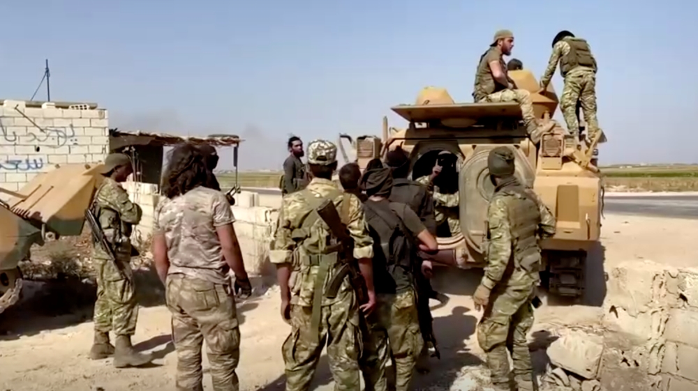 Syrian rebel soldiers leave their base near Tal Abyad
