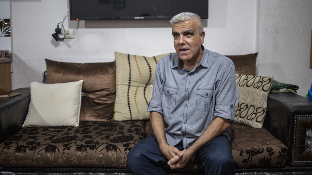 Ibrahim Jaddou speaks as he sits in his living room in Turkey's Sanliurfa 