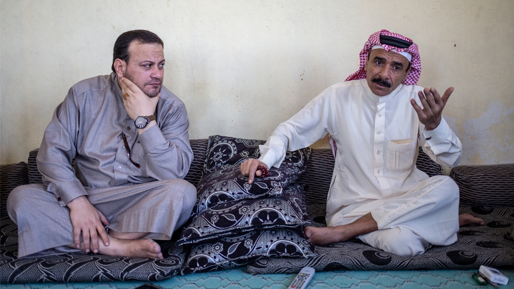 1) Mahmoud Asaad, gestures as he speaks alongside his friend from nearby Raqqa province [Farah Najjar/ Al Jazeera]