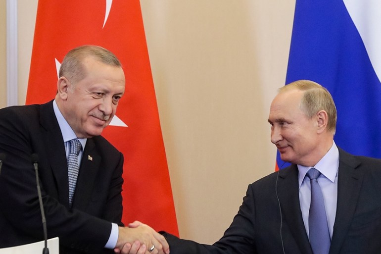 Russian President Vladimir Putin, right, and Turkish President Recep Tayyip Erdogan shake hands after their joint news conference following their talks in the Bocharov Ruchei residence in the Black Se