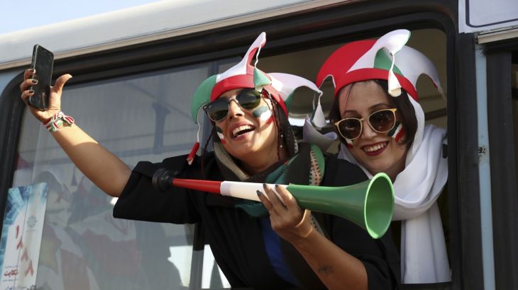 Caption: Iranian women cheer as they arrive to the Azadi Stadium to watch the 2022 World Cup qualifier soccer match between Iran and Cambodia, in Tehran, Iran, Thursday, Oct. 10, 2019