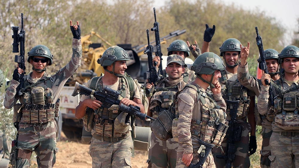 In this Monday, Oct. 14, 2019 photo, Turkish troops deploy in Syria's northern region of Manbij. Syrian state media said Tuesday that government forces have entered the center of the once Kurdish-held