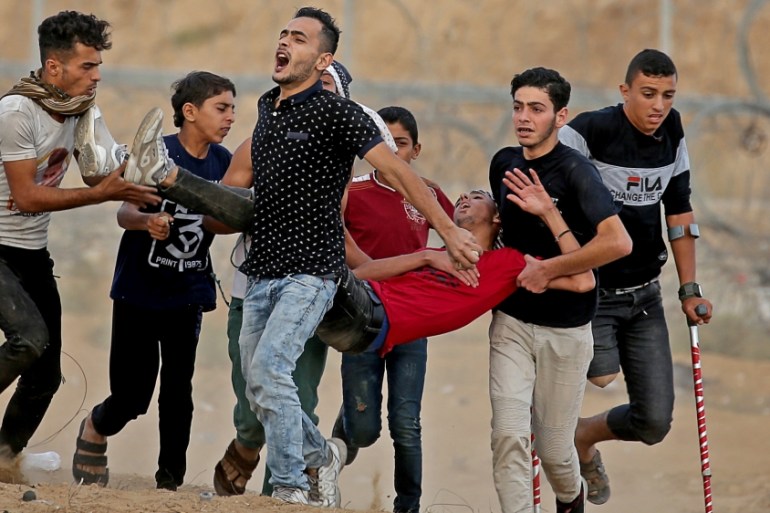 Wounded Palestinian is evacuated during an anti-Israel protest at the Israel-Gaza border fence in the southern Gaza Strip