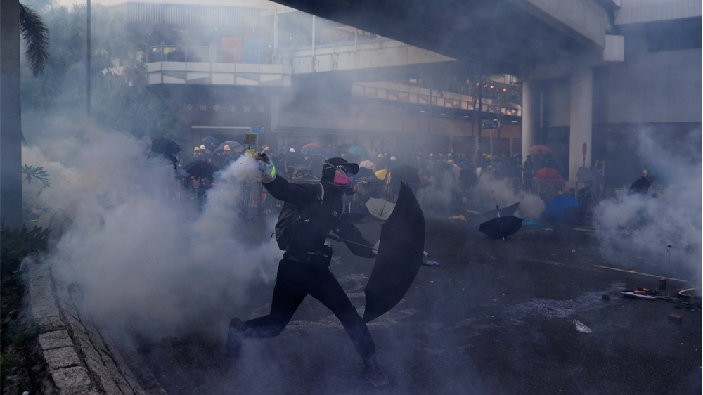 An anti-government protester throws a tear gas canister during a protest in Sha Tin district, on China's National Day in Hong Kong, China October 1, 2019. REUTERS/Jorge Silva