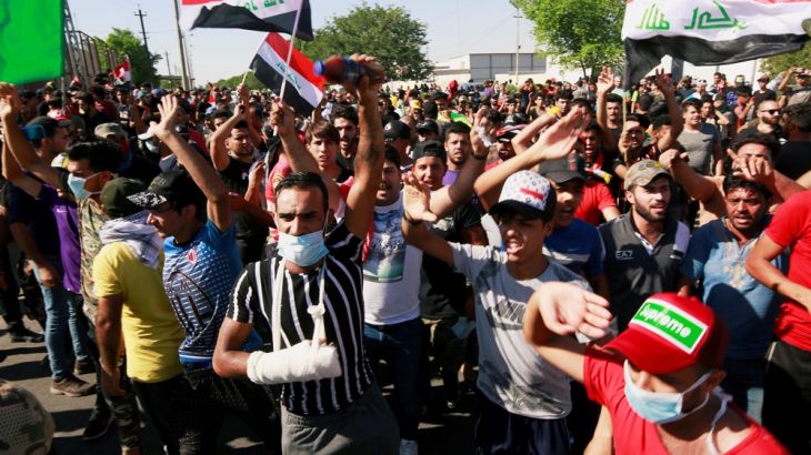 Demonstrators gather at a protest during a curfew, three days after the nationwide anti-government protests turned violent, in Baghdad