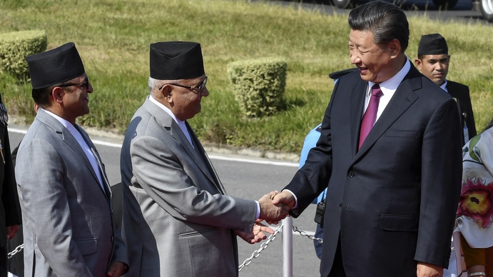 China's President Xi shakes hands with Nepal's PM Oli in Kathmandu