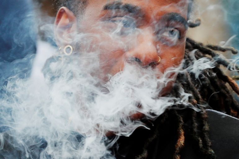 A demonstrator vapes during a protest in Boston